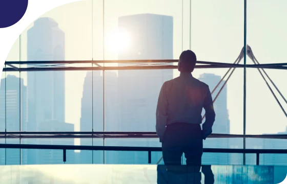 Two hands shaking over financial documents