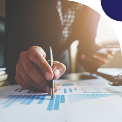 Two hands shaking over financial documents